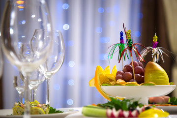 Plate of fruit on the holiday table. Christmas table