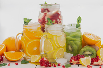 Fruit juices on a wooden white table. Useful and delicious vitamins. 