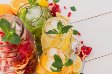 Fruit juices on a wooden white table. Useful and delicious vitamins. 