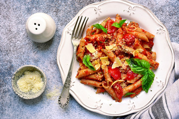 Wholewheat penne pasta with bolognese sauce.Top view with copy space.