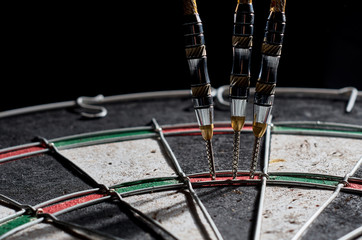darts. 3 darts in triple 20. Black background