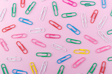 Background made from colored paper clips on the light pink base