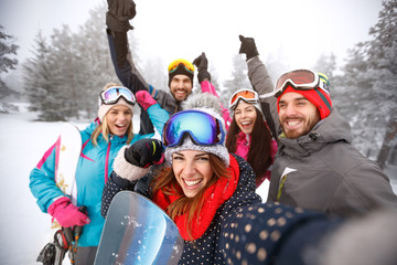 Vrienden met handen omhoog op skiën