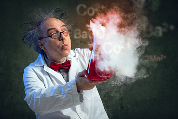 Chemist blowing in his experiment - obrazy, fototapety, plakaty