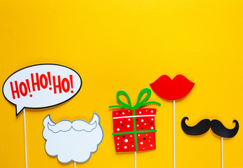 Cute New year and Christmas party props accessories on colorful yellow background, happy new year...