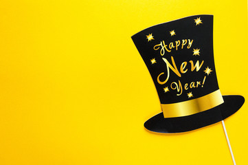 Cute New year and Christmas party props accessories on colorful yellow background, happy new year...