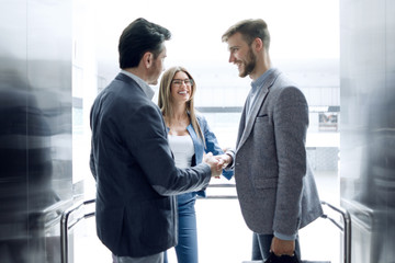 business people stretching out their hands for a handshake