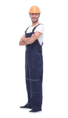 in full growth. confident man wearing overalls and a crash helmet.