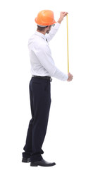 in full growth. young architect with yellow tape measure