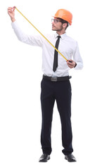 in full growth. young architect with yellow tape measure