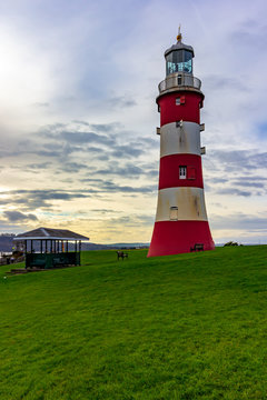 Smeaton's Tower under a colorful dramatic sky. It is a prominent landmark in Hoe Park, Plymouth, England