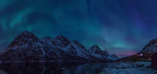 Northern lights panorama over norwegian fjord