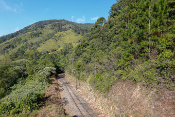 Railroad stretch between hills and forest