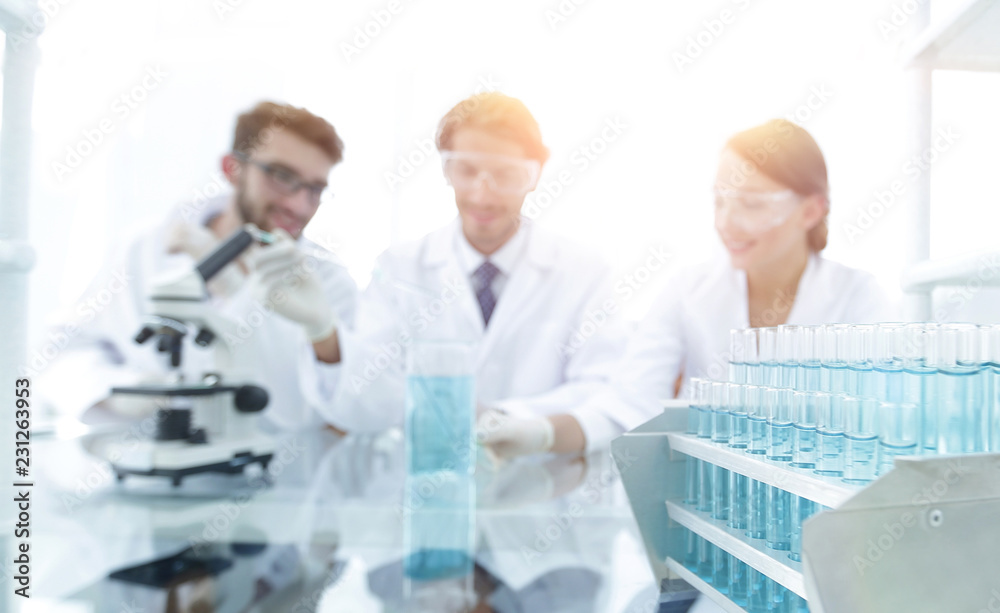 Wall mural background image of scientists studying blue liquid in a flask