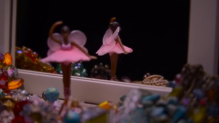 WINGED BALLERINA TURNING INSIDE A JEWELRY MUSIC BOX.  4K SLIDER SHOT.  Version 2 of 2.