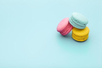 macaroon on blue background, colored macaron, top view, copy space