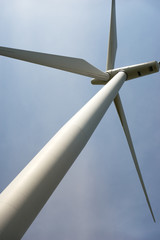 Looking up at a wind turbine