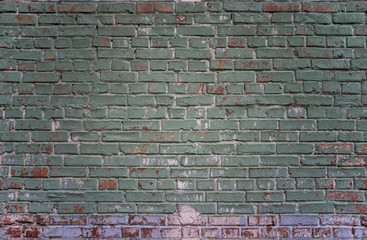 Tiled grunge industrial green and red brick wall background in Kyiv, Ukraine. May be used in design and interiors.