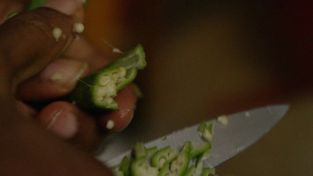 Close up of okra being cut and prepared for cooking