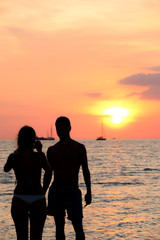 silhouette tourist On the beach Sunset