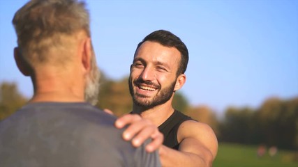 The happy son and a father talking on the sunny background. slow motion