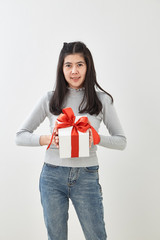 Fototapeta premium Young woman happy hold gift box in hands