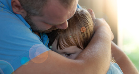 Close up portrait of caucasian father hugging and consoling sad daughter / Emmontional fatherhood...