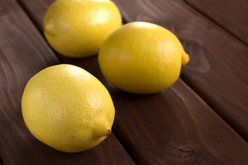 fresh lemons on wooden table