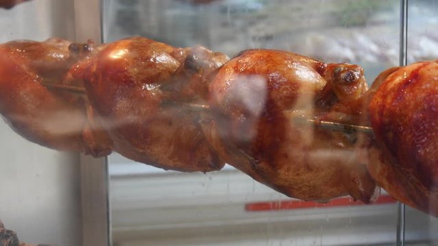 Roasted chicken in a row turning at Rotating machine.