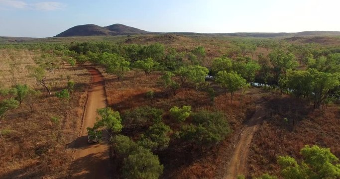 Aerial view of 4WD vehicle driving along an outback track in the Kimberley, Australia