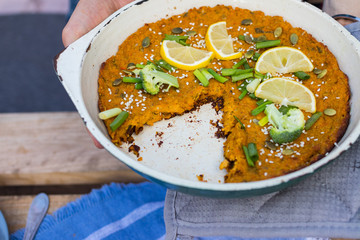 Vegetable pumpkin casserole with green parsley and lemon slices. Vegan lunch, vegetarian dinner, healthy paleo diet. Top down view