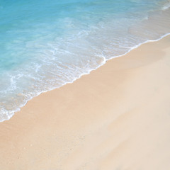 Paradise shoreline with turquoise water and white sandy beach. Space for text.