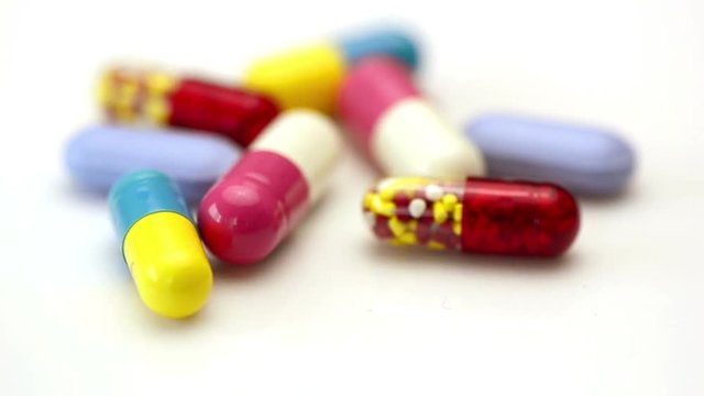 Oral medication background with warm light.Colorful of oral medications on White Background.