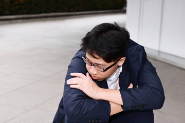 Anxiety stressed young Asian business man suffering from severe trouble