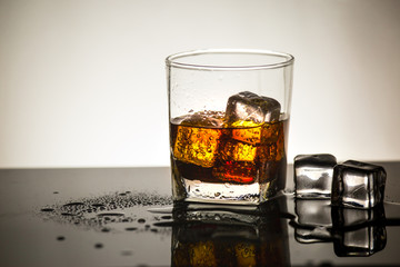 Beverage from cola in glass with ice in studio lighting,beverage in summer is sparkling water
