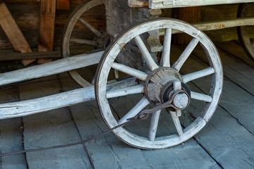 Fototapeta na wymiar Old wooden wheel from the cart.
