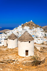 Traditional houses, wind mills and churches in Ios island, Cyclades, Greece.