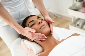 Fototapeta na wymiar Woman receiving head massage in spa wellness center.