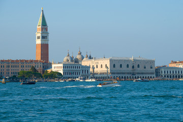 Fototapeta na wymiar The Campanile of St. Mark Cathedral and the Doge Palace on a sunny day. Venice