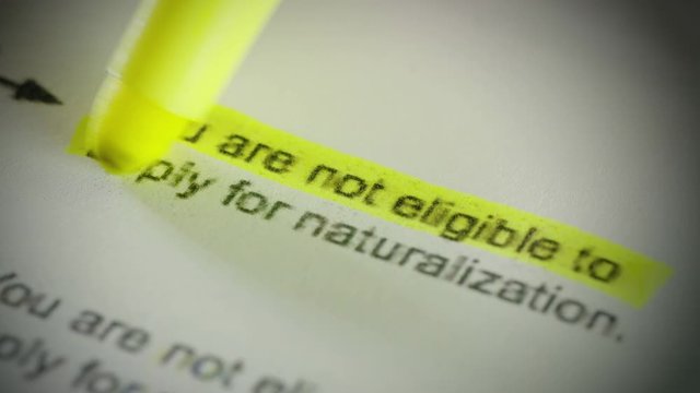 A highlighter marks "you are not eligible for naturalization" on a document