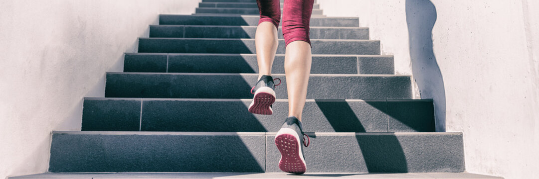 Active weight loss training workout running up stairs for hiit workout cardio training. Staircase climbing run woman going run up steps panorama banner. Runner athlete doing sport workout.