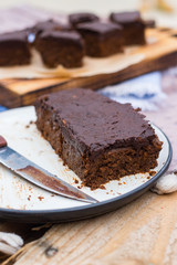 Vegan chocolate sweet brownie cake on plate. Pumpkin, cacao powder, Iranian dates. No bake....
