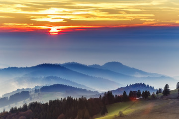 Dramatic sunset over Black forest mountains in Germany. Scenic travel background.