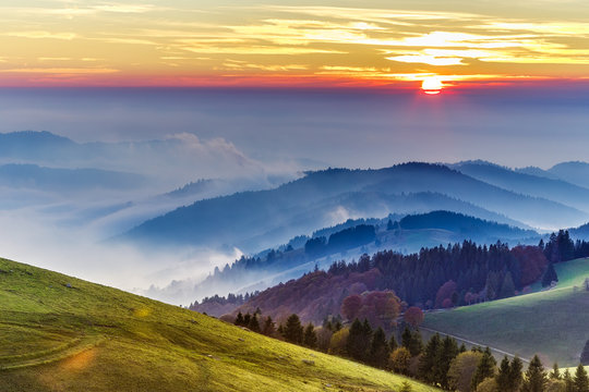 Dramatic sunset over rolling hills of the Black forest in Germany. Scenic travel background.