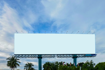 White advertising billboard on blue sky .