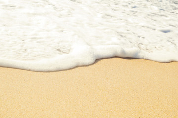 Water edge and sand. Close-up summer beach background. Vacation and traveling concept.