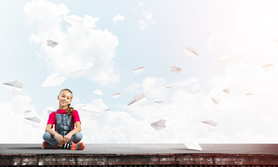 Concept of careless happy childhood with girl of school age smilling