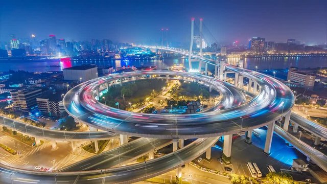 Famous highway intersection in Shanghai, China. Big modern city by night. 4K Time lapse.