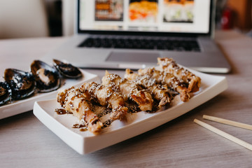 Delivery of Japanese cuisine. Registration of delivery on the website by laptop