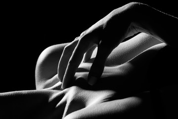sensual female topless body on black background, monochrome